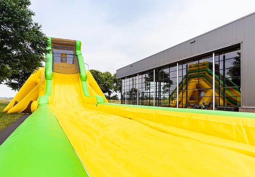 Bestel opblaasbare super grote glijbaan van 46 meter in het groen met geel